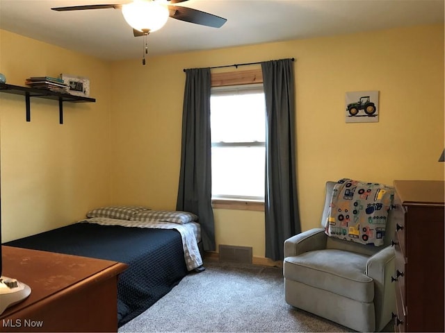 carpeted bedroom with ceiling fan and visible vents