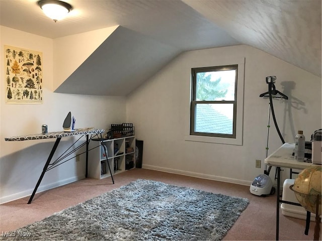 office space featuring lofted ceiling, carpet floors, and baseboards