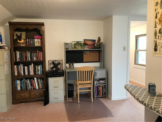 home office featuring lofted ceiling, baseboards, and carpet flooring