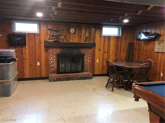 rec room featuring wooden walls, a brick fireplace, billiards, and tile patterned floors