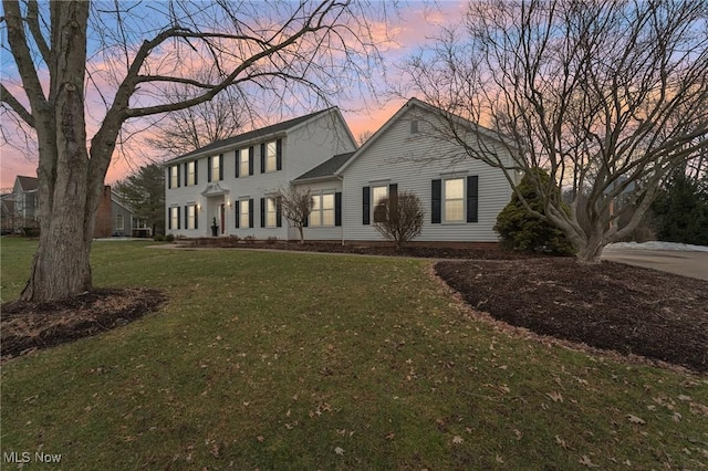 colonial-style house featuring a yard