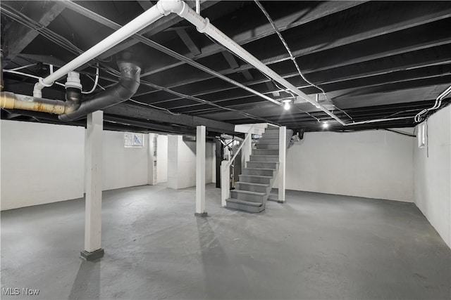 unfinished basement featuring stairway