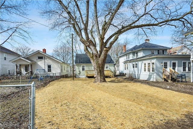 view of yard with entry steps, fence, and a residential view