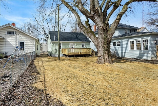 back of house with a deck and fence