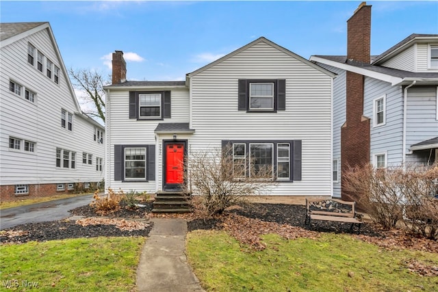 traditional home featuring a chimney