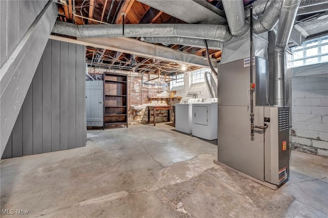 basement featuring heating unit and independent washer and dryer