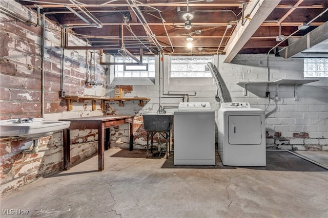 below grade area with a workshop area, a sink, and washer and dryer