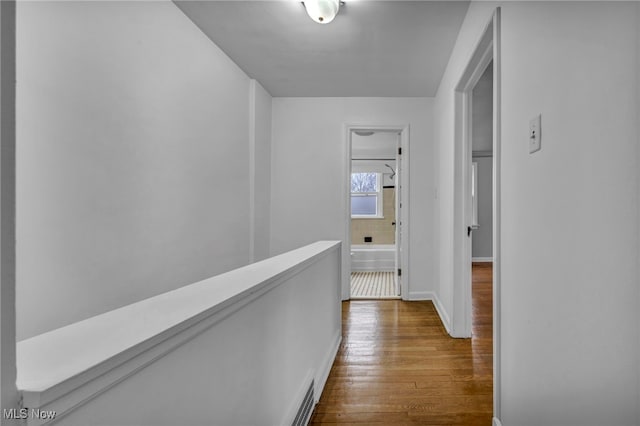 hall featuring baseboards and dark wood finished floors