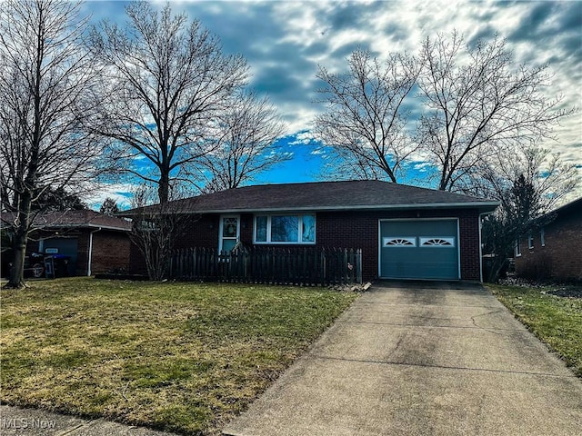 ranch-style house featuring a garage, a front yard, brick siding, and driveway