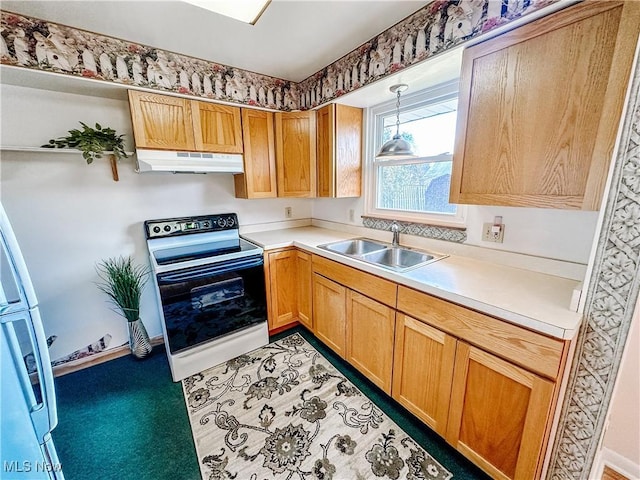 kitchen with electric stove, light countertops, hanging light fixtures, a sink, and under cabinet range hood