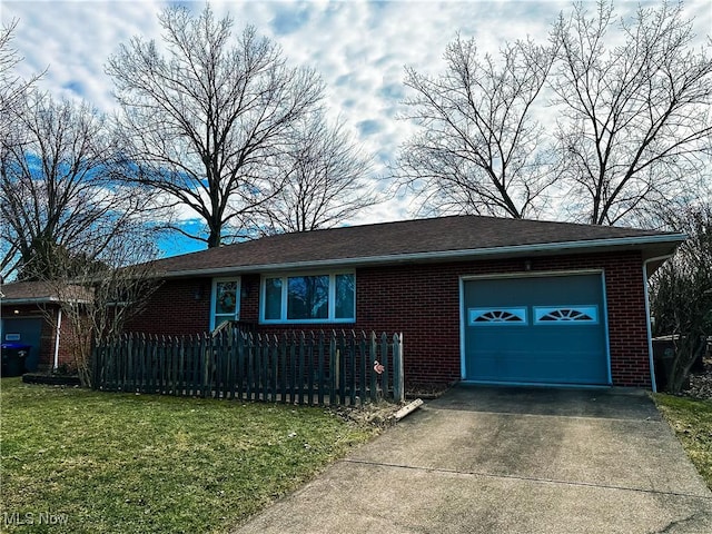 ranch-style house with a fenced front yard, aphalt driveway, brick siding, a garage, and a front lawn