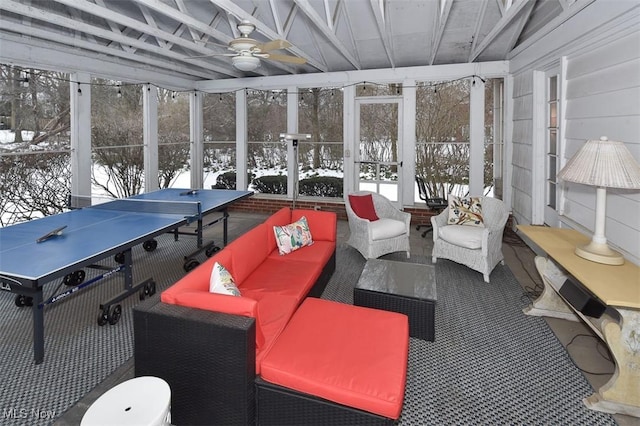 sunroom / solarium featuring a ceiling fan