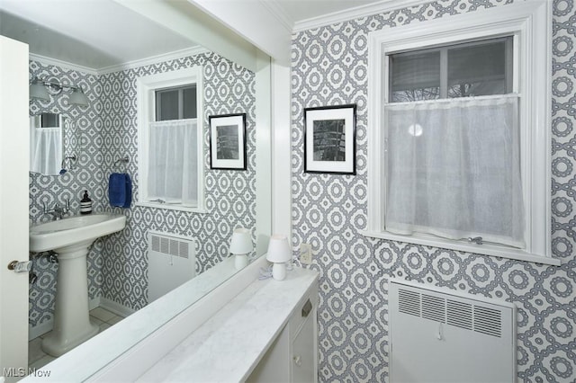 bathroom featuring wallpapered walls, radiator heating unit, and ornamental molding