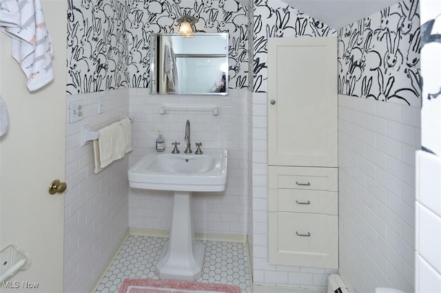 bathroom featuring wainscoting, tile walls, and wallpapered walls