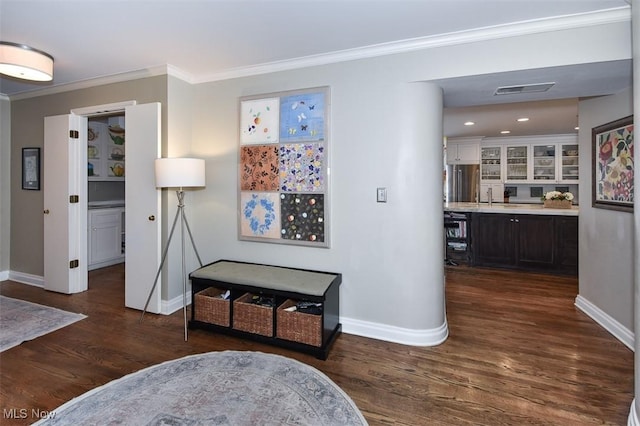 corridor featuring baseboards, dark wood-style flooring, and crown molding