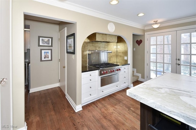 kitchen with ornamental molding, white cabinets, dark wood finished floors, and tasteful backsplash