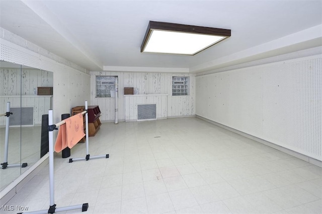 finished below grade area featuring a fireplace and tile patterned floors