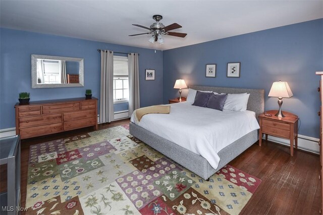 bedroom with a ceiling fan, a baseboard heating unit, and wood finished floors