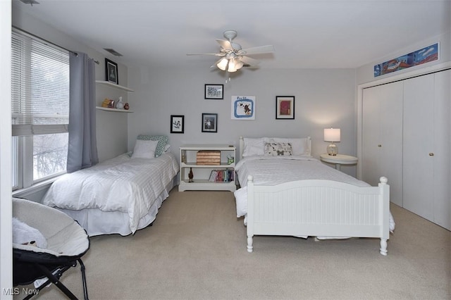 bedroom featuring carpet, a closet, visible vents, and ceiling fan