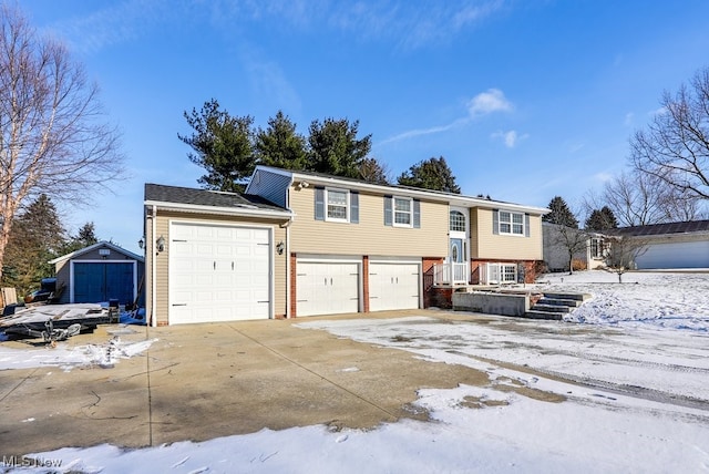 bi-level home featuring a garage, concrete driveway, and brick siding