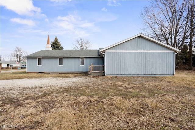 back of property featuring a garage