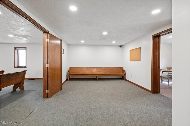 basement with a textured ceiling, carpet floors, recessed lighting, and baseboards