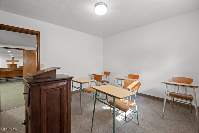 interior space with carpet, a textured ceiling, and baseboards