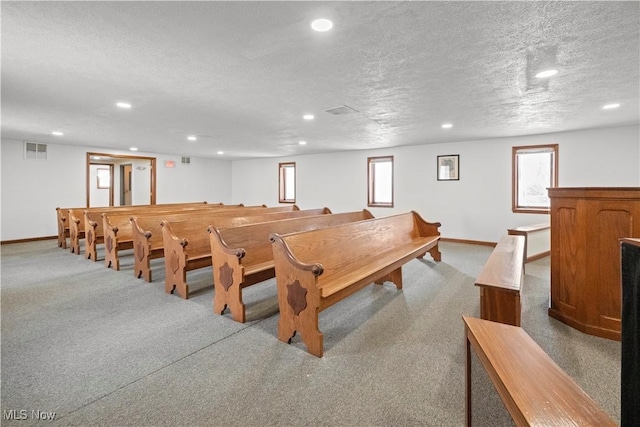 rec room with a textured ceiling, carpet, visible vents, and recessed lighting