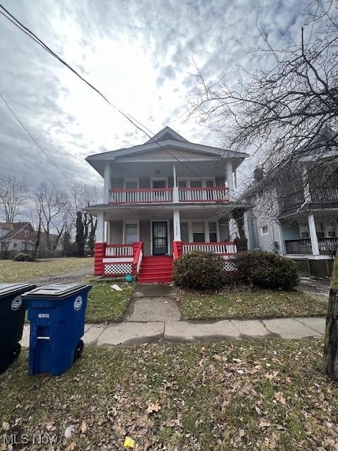 view of front facade with a balcony and a porch