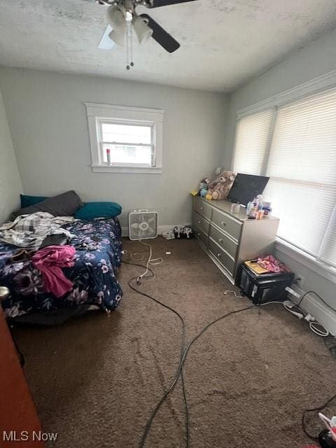 bedroom with ceiling fan, a textured ceiling, carpet, and baseboards