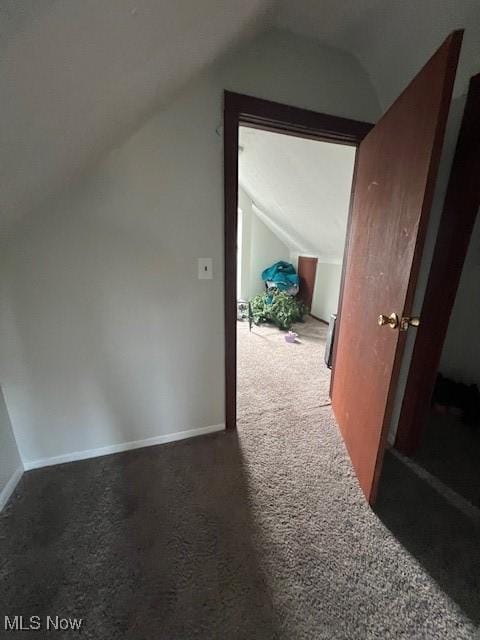 additional living space with vaulted ceiling, carpet floors, and baseboards