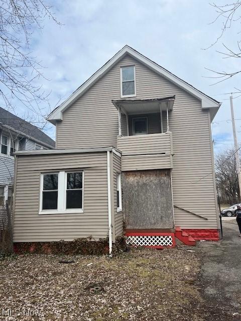 back of house featuring a balcony