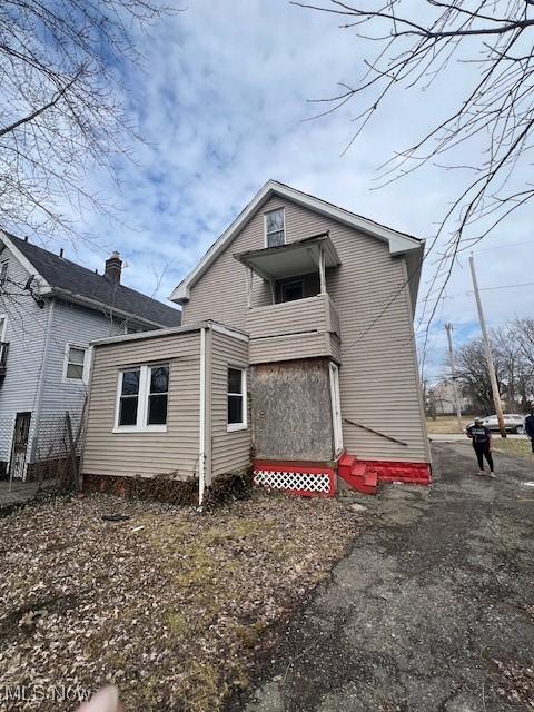 back of property featuring entry steps