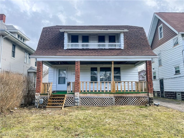 view of front of home with a porch, a shingled roof, a balcony, and a front lawn