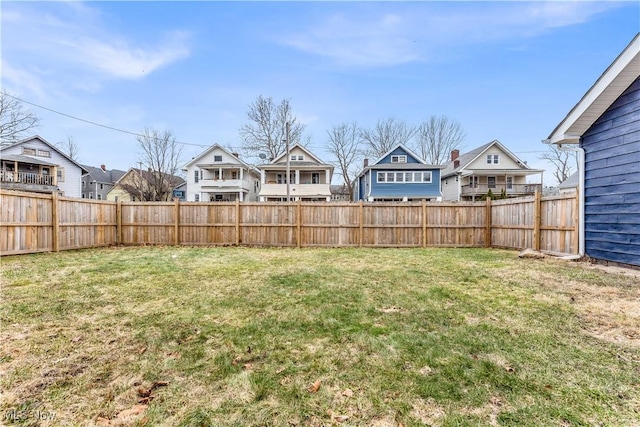 view of yard featuring a residential view and fence