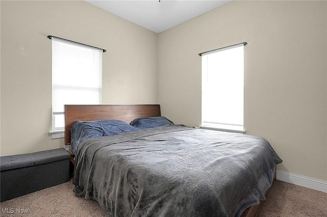 carpeted bedroom featuring baseboards