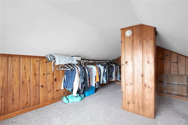 walk in closet with lofted ceiling and carpet floors