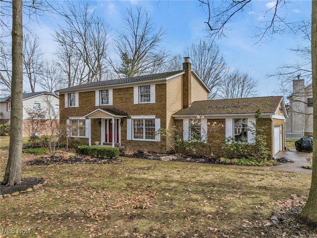 view of front of home featuring brick siding, a chimney, and an attached garage