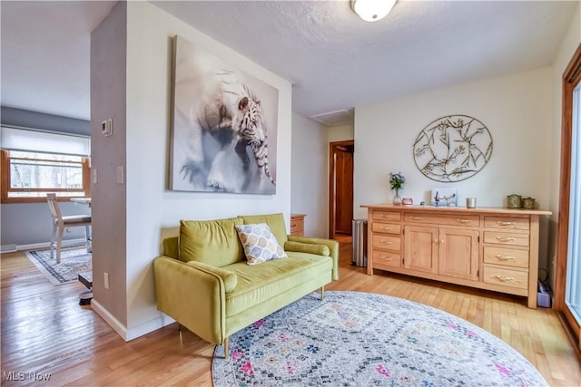 sitting room with light wood-style flooring and baseboards