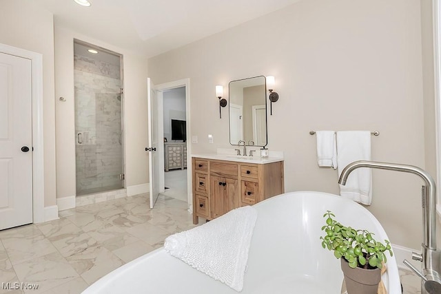 bathroom with vanity, baseboards, a freestanding bath, marble finish floor, and a stall shower