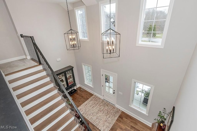 entryway featuring plenty of natural light, stairway, and wood finished floors