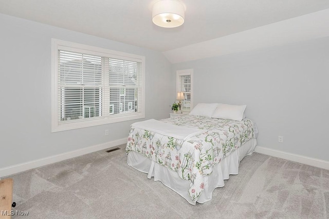 bedroom featuring carpet floors, vaulted ceiling, and baseboards