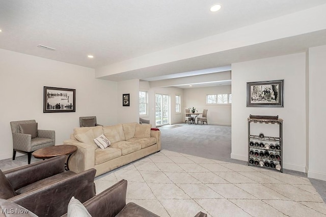 living room with recessed lighting, visible vents, light carpet, and baseboards