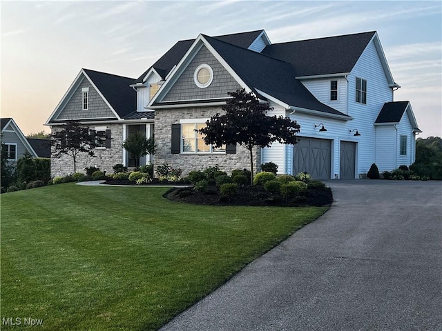 view of front of house with driveway and a yard