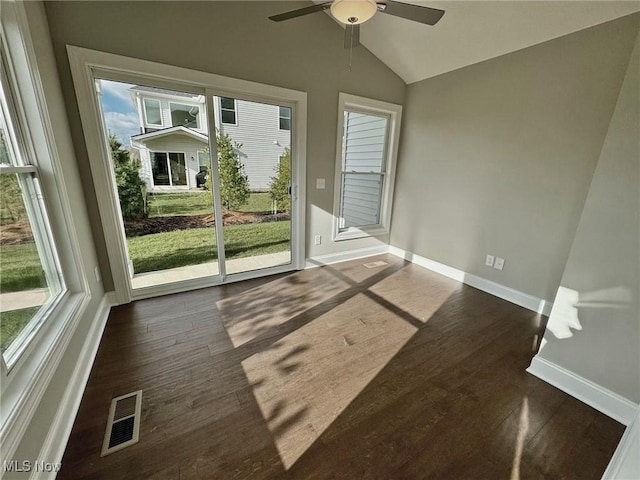 interior space with a ceiling fan, lofted ceiling, and visible vents