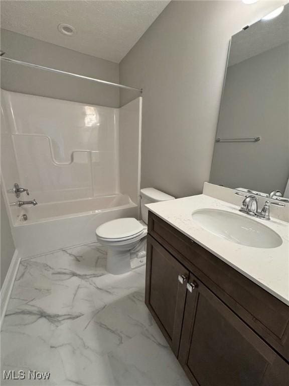 bathroom featuring a textured ceiling, marble finish floor, shower / tub combination, and toilet