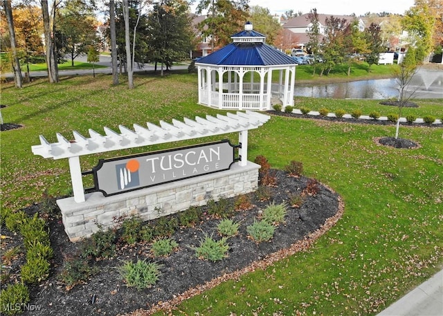 view of home's community featuring a yard, a water view, and a gazebo