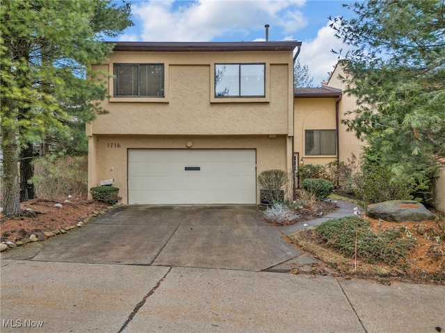 view of front of home featuring stucco siding, driveway, and an attached garage