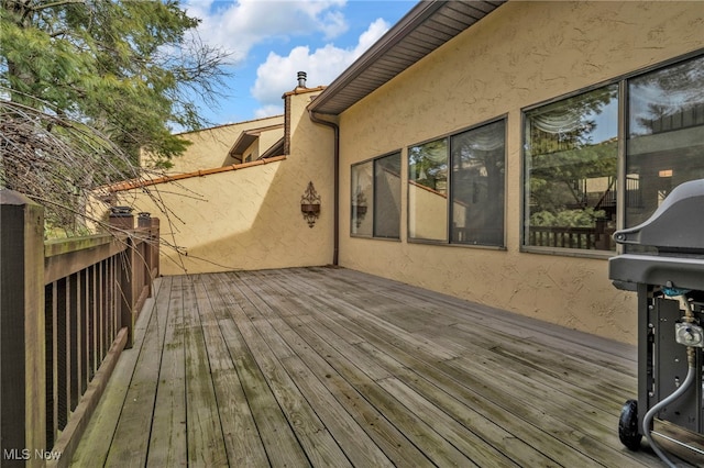 wooden deck with grilling area