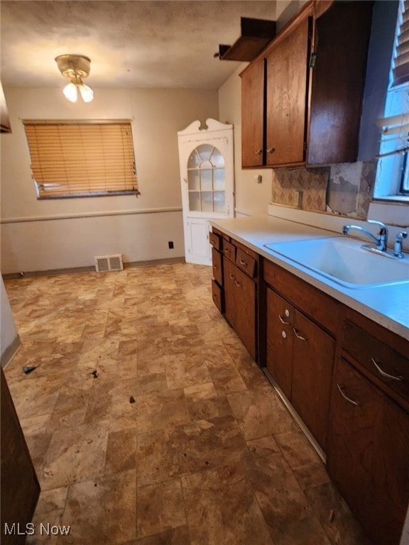 kitchen featuring light countertops, a sink, and visible vents